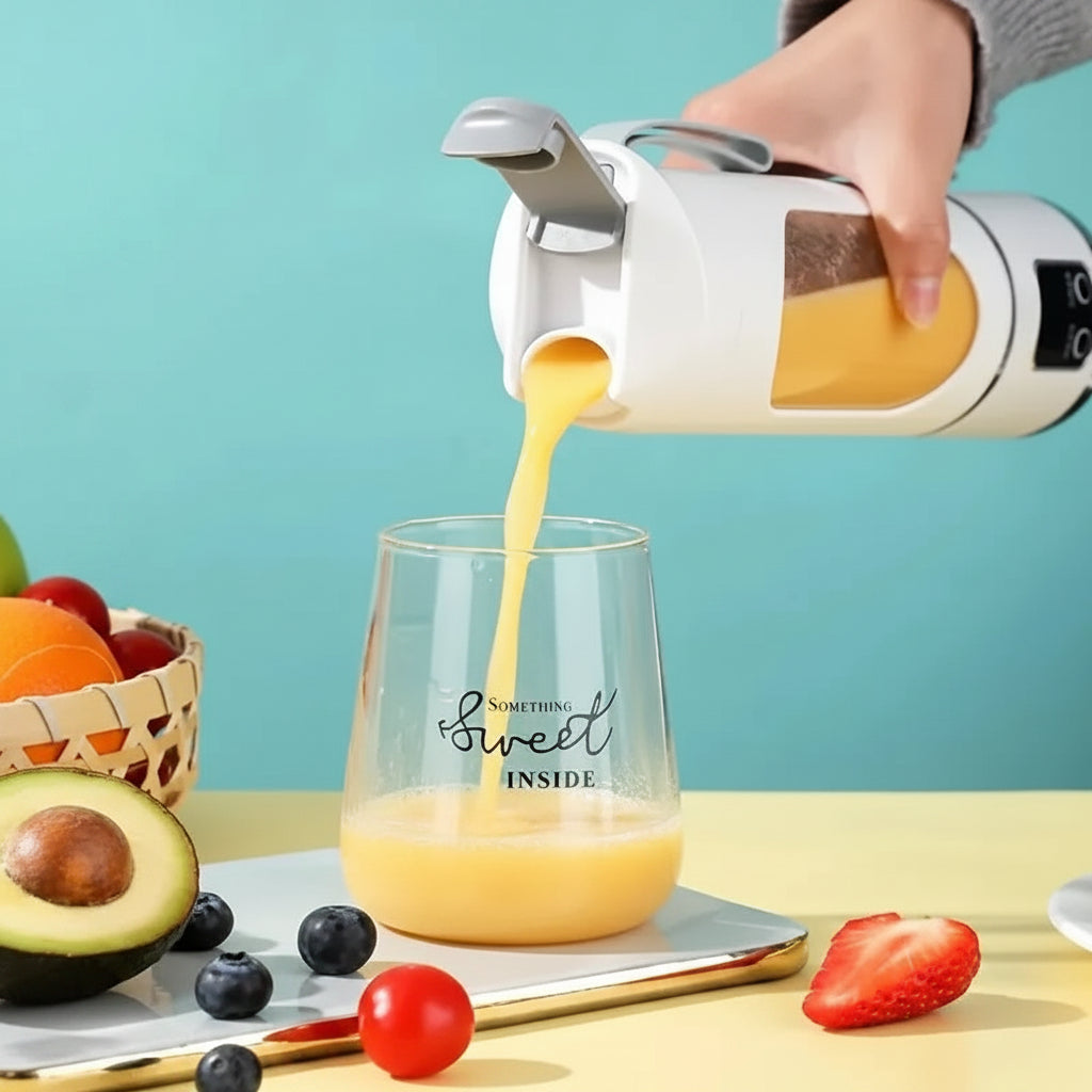 Hand pouring orange juice from a white and silver electric juicer into a glass with fruit on a table.